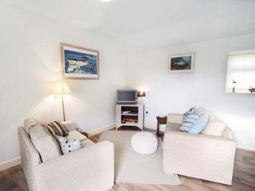 a living room with two couches and a tv at Shrimp Cottage - E5415 in Kessingland