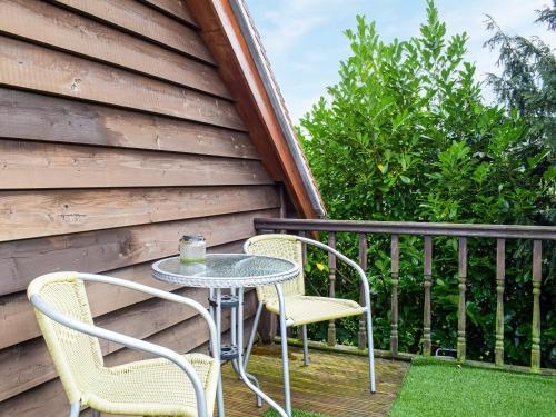 a table and two chairs on a balcony at The Studio in Dinmore