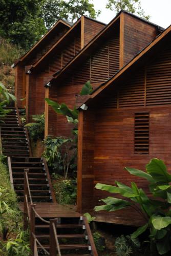a wooden building with stairs leading up to it at Solana Mar y Selva Boutique in Bahía Solano