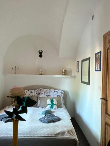 a bedroom with a bed with a cross on the wall at Apartmány na Náměstí in Český Brod