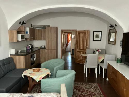a living room with a couch and a table at Apartmány na Náměstí in Český Brod