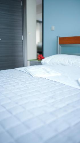 a close up of a bed with white sheets and pillows at Urban Nest in Alexandroupoli