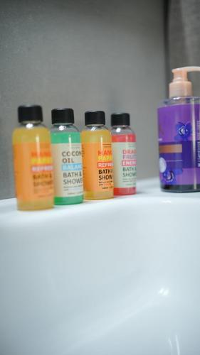 a row of different colored liquids sitting on a shelf at Urban Nest in Alexandroupoli