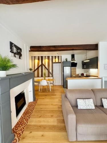 un salon avec un canapé et une cheminée dans l'établissement Le Saint Melaine, Hyper centre de Rennes, à Rennes