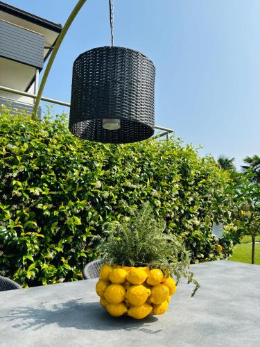 a bowl of oranges sitting on a table with a light at Haus Wiesenstein in Lana