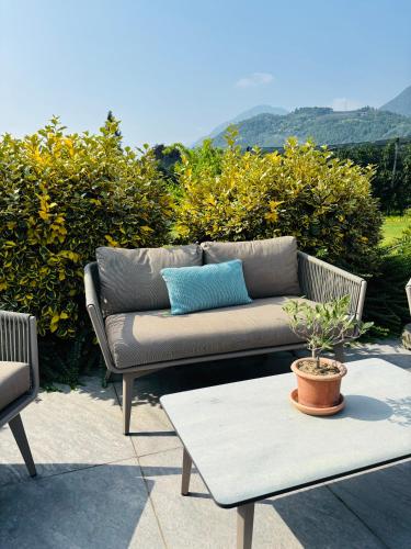 a couch sitting on a patio with a table at Haus Wiesenstein in Lana