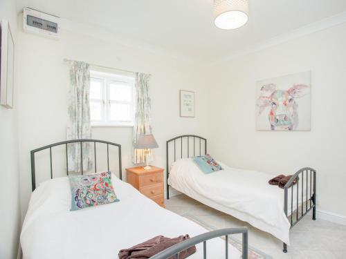 a bedroom with two beds and a window at Stargazer - Uk43267 in Luppitt