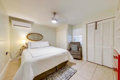 a bedroom with a bed and a chair in it at 5 Mi to Surfside Beach Peaceful Miami Bungalow! in Miami