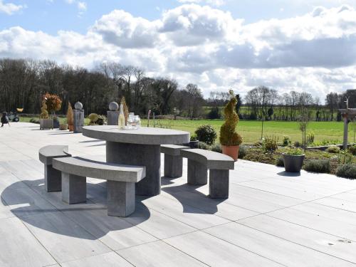 a picnic table and benches in a park at Park Barn in Whittington