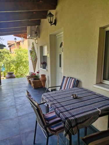 a porch with a table and chairs on a patio at Vasilija in Sremski Karlovci