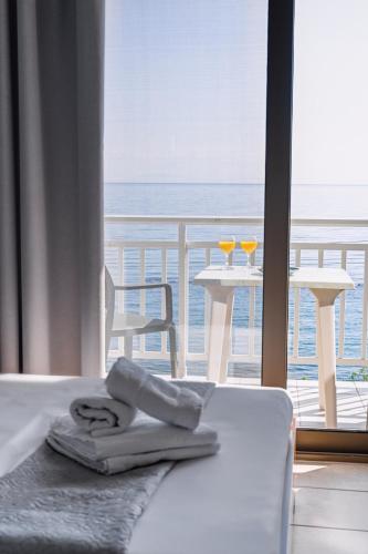a hotel room with a bed with a view of the ocean at Anesis in Platamonas