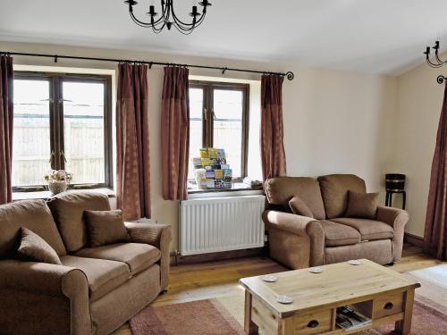 a living room with two couches and a coffee table at Horseshoes - E5369 in West Buckland