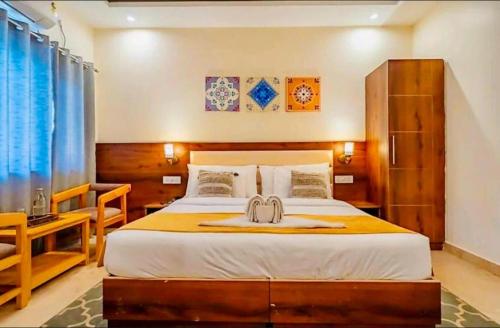 a bedroom with a large bed and a desk at The Shore Travelista in Rishīkesh