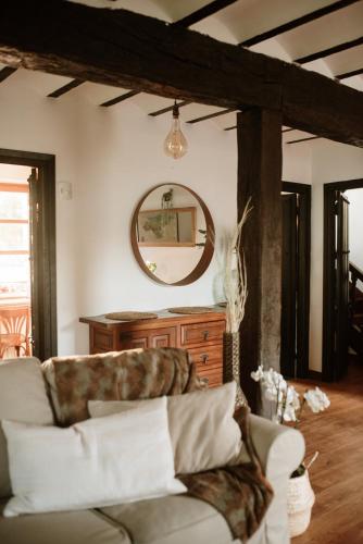 a living room with a couch and a mirror at Hotel Palacio de Caranceja in Reocín