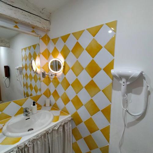 a bathroom with a sink and a mirror at Le Cocon des Trois Marmottes in Saillans
