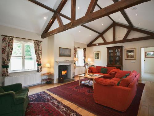 a living room with two couches and a fireplace at Ware House Cottage in Lyme Regis