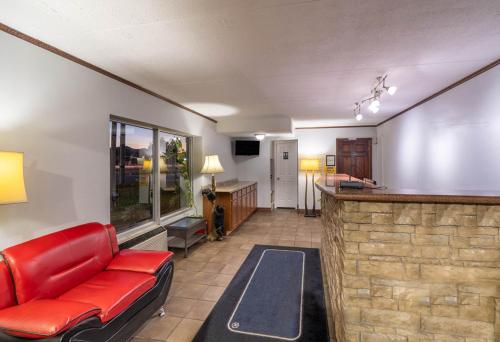 a living room with a red couch and a bar at Pigeon Forge Parkway Inn in Pigeon Forge