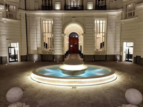 a large building with a large fountain in the middle at Guli's Suite - Lusso e Comfort in Centro Storico in Naples