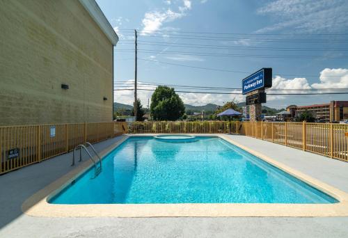 a swimming pool in front of a hotel at Pigeon Forge Parkway Inn in Pigeon Forge