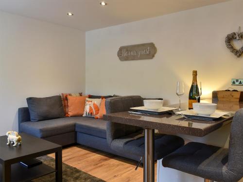 a living room with a couch and a table at Swaledale Cottage - Barley Green Mill in Barrowford