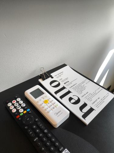 a remote control and a piece of paper with the word outcome at Albert Studio in Art Nouveau building with AC Top location near old town in Rīga