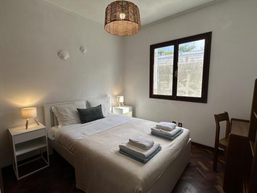 a bedroom with a bed with towels on it at Sailor House - By Wehost in Porto Santo