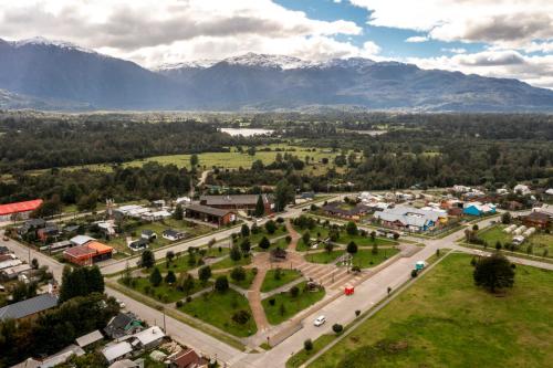 an aerial view of a town with mountains in the background at Alto Melimoyu Hotel & Patagonia in La Junta