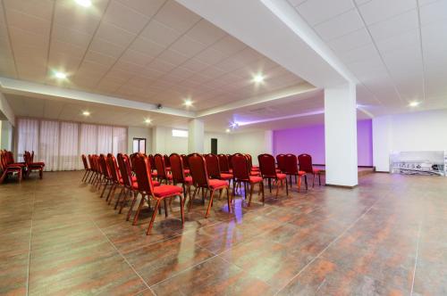 a room with a bunch of red chairs in it at Hotel Fontana Plaza in Torrevieja