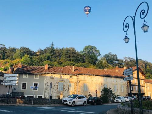 a street with cars parked in front of a building at Gite Coccinelle in the medieval town of Confolens in Confolens