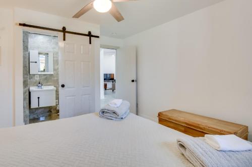 a white bedroom with a bed and a sink at Bright Oasis on Lake Hartwell with Boat Dock! in Anderson