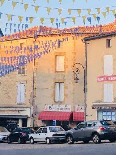 a group of cars parked in front of a building at Gite Coccinelle in the medieval town of Confolens in Confolens