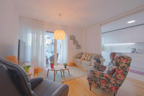 a living room with a couch and a table at Benfica Prime Terrace II by Homing in Lisbon