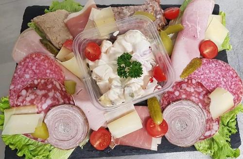 a tray of food with cheese and meats and vegetables at Au domaine des anges, 3 gîtes luxueux avec Jacuzzi privatif, sauna, mini-piscine, piscine extérieure chauffée en saison in Bain-de-Bretagne