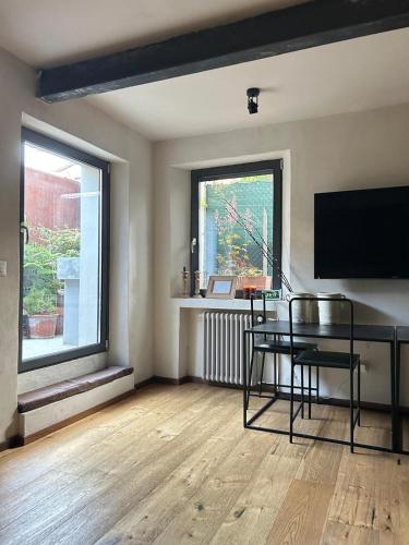 an empty living room with a table and a television at Casa Gastone in Rimini
