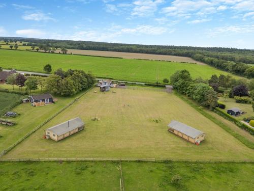 an aerial view of a large field with tents at Fallow - Uk47397 in Bawdeswell