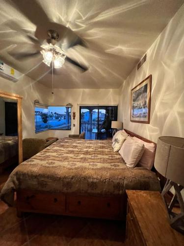 a bedroom with a bed with a ceiling fan at The House of Angels in Las Conchas
