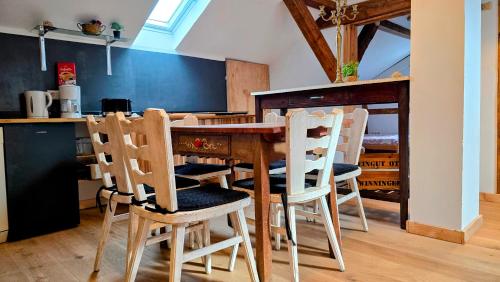 a kitchen with a wooden table and chairs at Ferienwohnungen Otus in Winningen