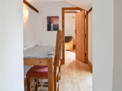 a kitchen and dining room with a table and chairs at Cobbler's Retreat in Birley