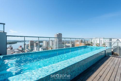 a swimming pool on the roof of a building at TCO - Apartamentos no Centro Histórico Porto Alegre/RS in Porto Alegre