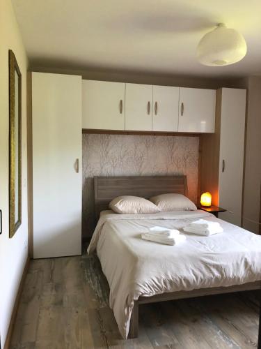 a bedroom with a large bed with two towels on it at Independent studio in a chalet in Mont-Saxonnex