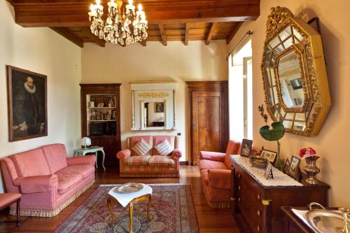a living room with pink furniture and a mirror at Villa Giani in Annone di Brianza