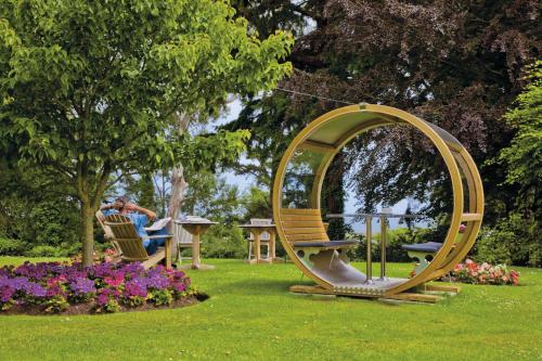 a man sitting in a chair in a circle in a park at Tinakilly Country House Hotel in Rathnew