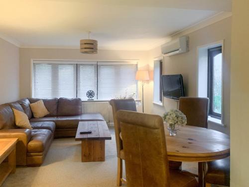 Sunbury Cottage في Clanfield: غرفة معيشة بها أريكة وطاولة