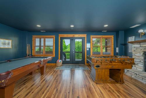 a room with a pool table and a fireplace at Whiskey Hills - Newly Remodeled Luxury Cabin with Hot Tub, Incredible Views close to Asheville, walk to Hatley Pointe & Ski! in Swiss