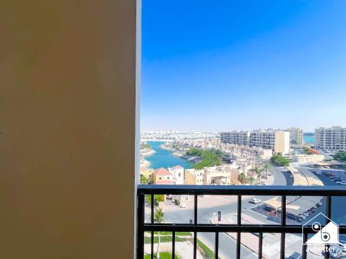 a room with a view of a city and a river at 1BR Getaway in RAK l Balcony , Pool and Gym Access in Ras al Khaimah