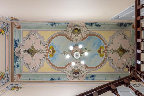 a ceiling with a chandelier in a room at Roze Boutique Apartments in Liepāja