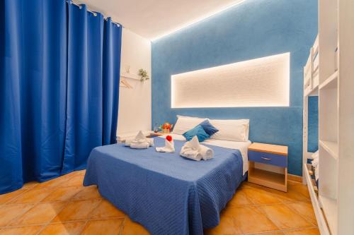 a blue bedroom with a bed with two stuffed animals on it at "L'Oasi di Favignana" Room and Charme in Favignana