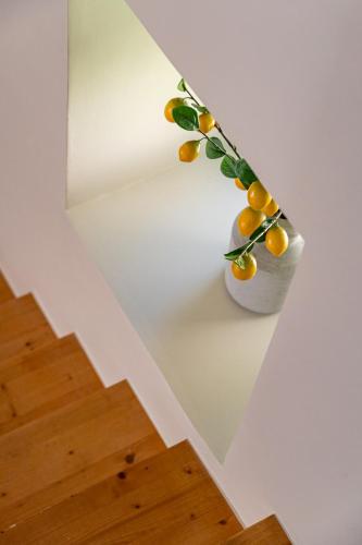 a plant in a white vase on a wall at Sea´ya Thoughtful Stays - Villa Areia in Cascais