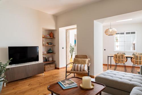 a living room with a couch and a table at Sea´ya Thoughtful Stays - Villa Areia in Cascais