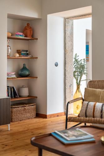 a living room with a chair and a table at Sea´ya Thoughtful Stays - Villa Areia in Cascais